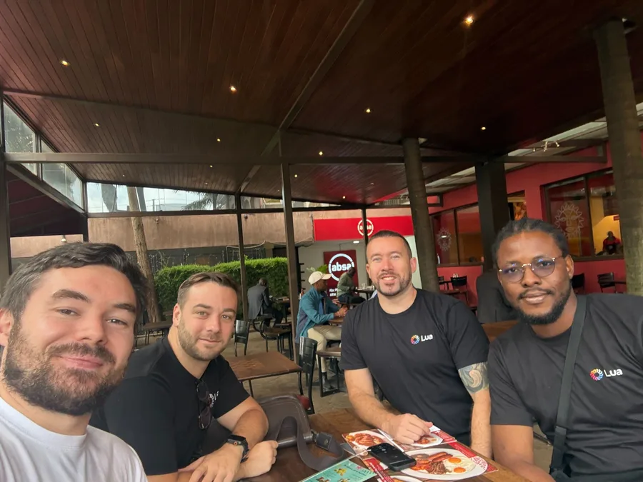 Four team members at breakfast before a day of customer visits