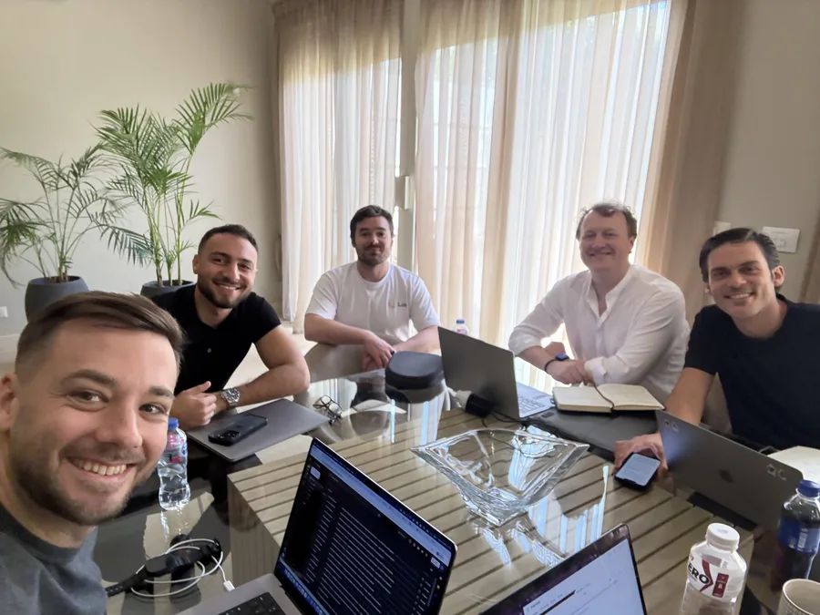 Five of the team working around one table at an offsite