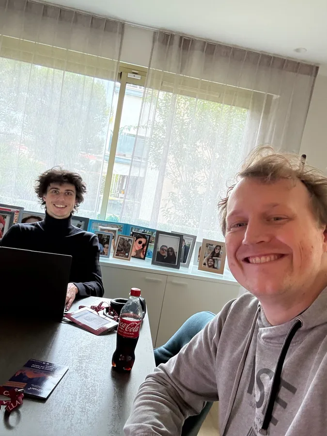 Two engineers heads-down at a desk in Poznań