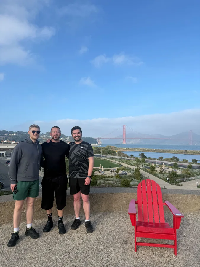 Three team members above the Presidio with the Golden Gate Bridge behind