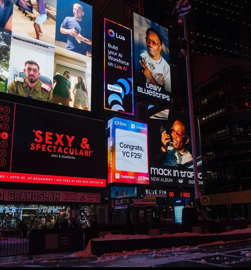 A Lua billboard in Times Square reading Build your AI Workforce on Lua AI