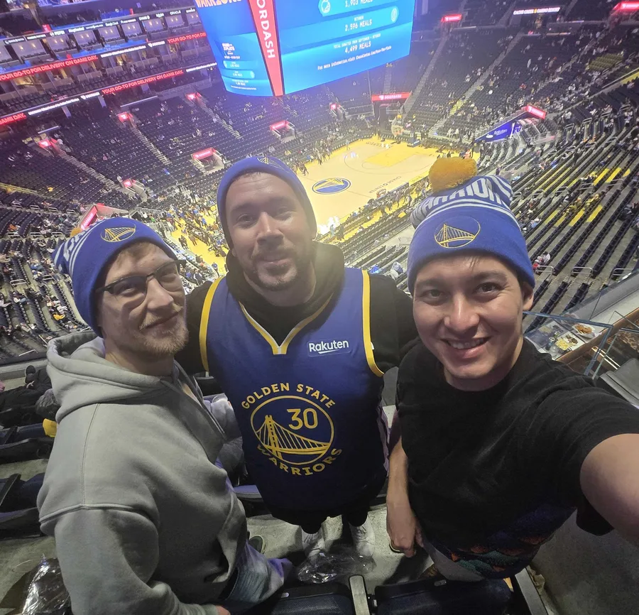 Three team members at a Warriors game at Chase Center